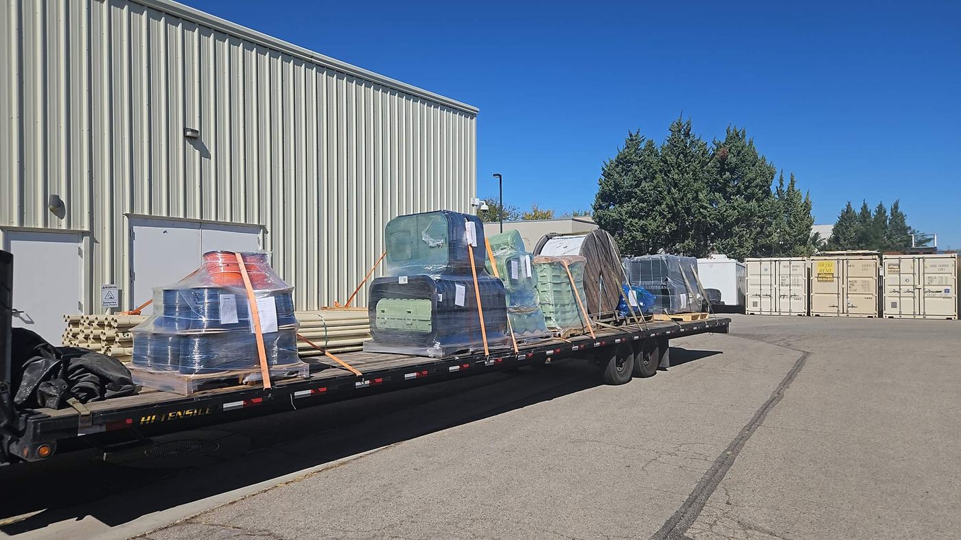 Palletized construction and utility materials strapped on an EXMULI flatbed